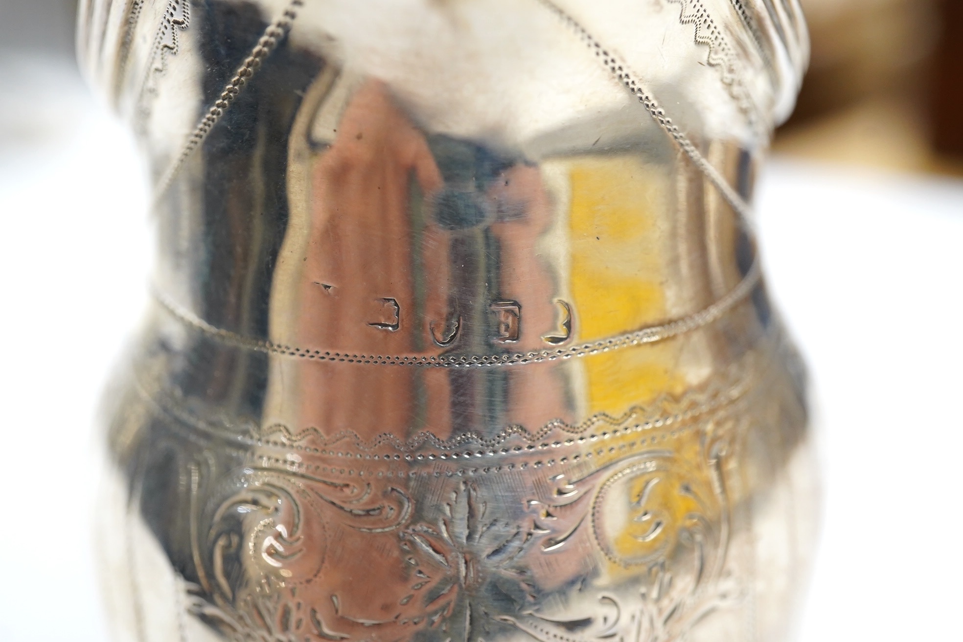 A George III engraved silver helmet shaped cream jug, London, 1801, 12.4cm, 3.4oz. Condition - poor